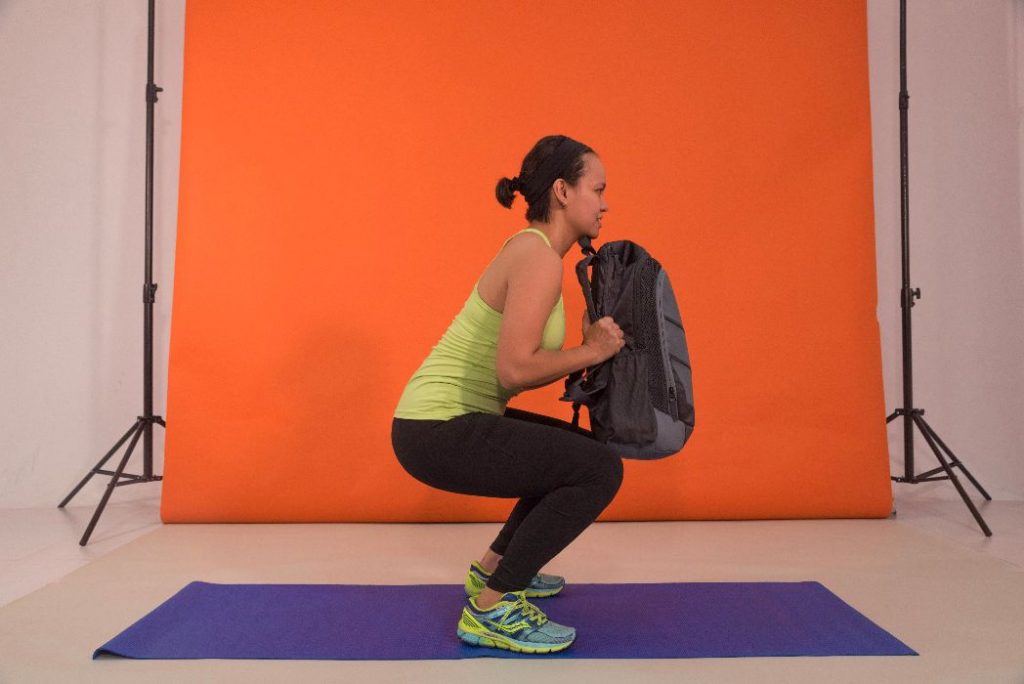 10-minute density workout: Squat to press with a bag 1