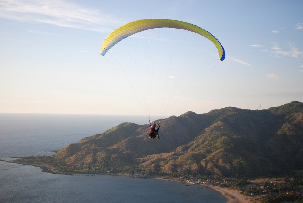 Certified pilots can take you on a tandem ride for several minutes before safely landing on the beach