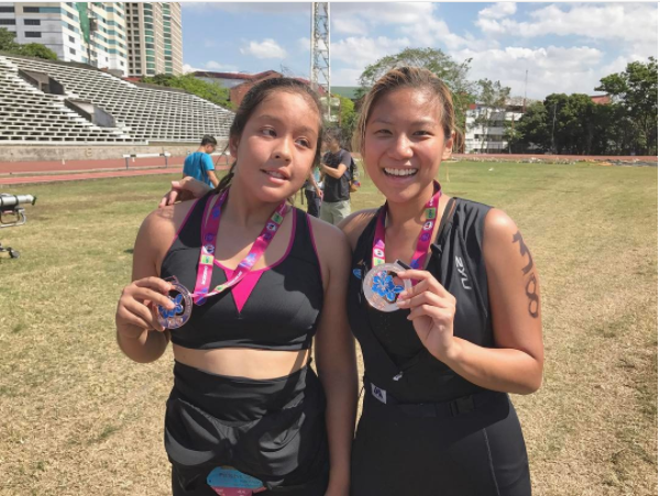 Katz Salao all smiles with 13-year-old Peggy, an athlete with autism, after finishing their first aquathlon