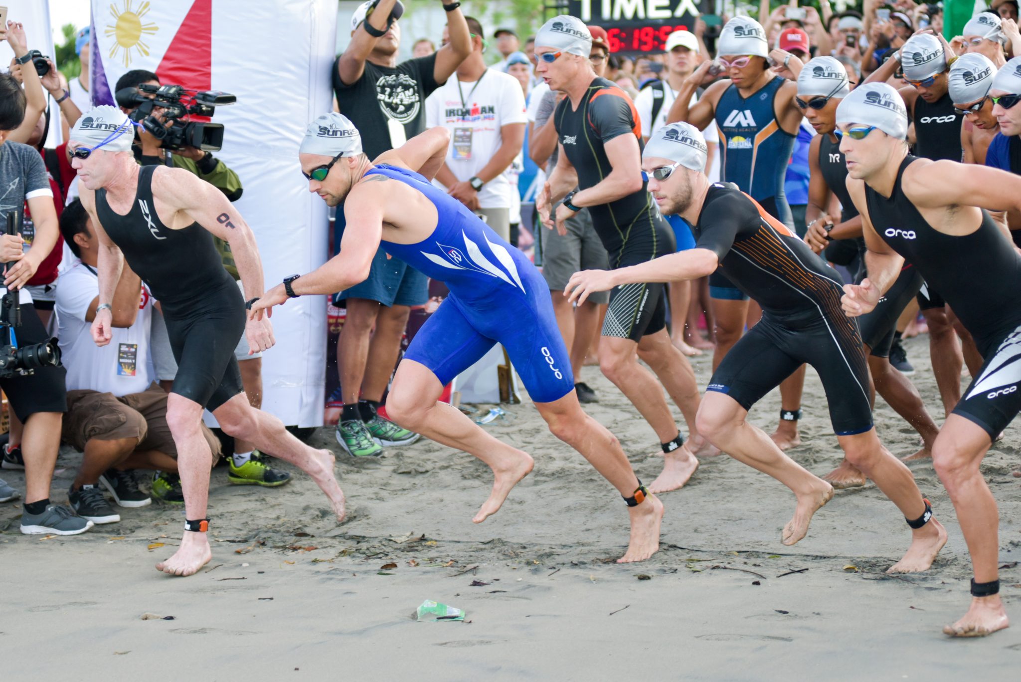 The men's pros dash off into the water to start the 3.8-kilometer swim