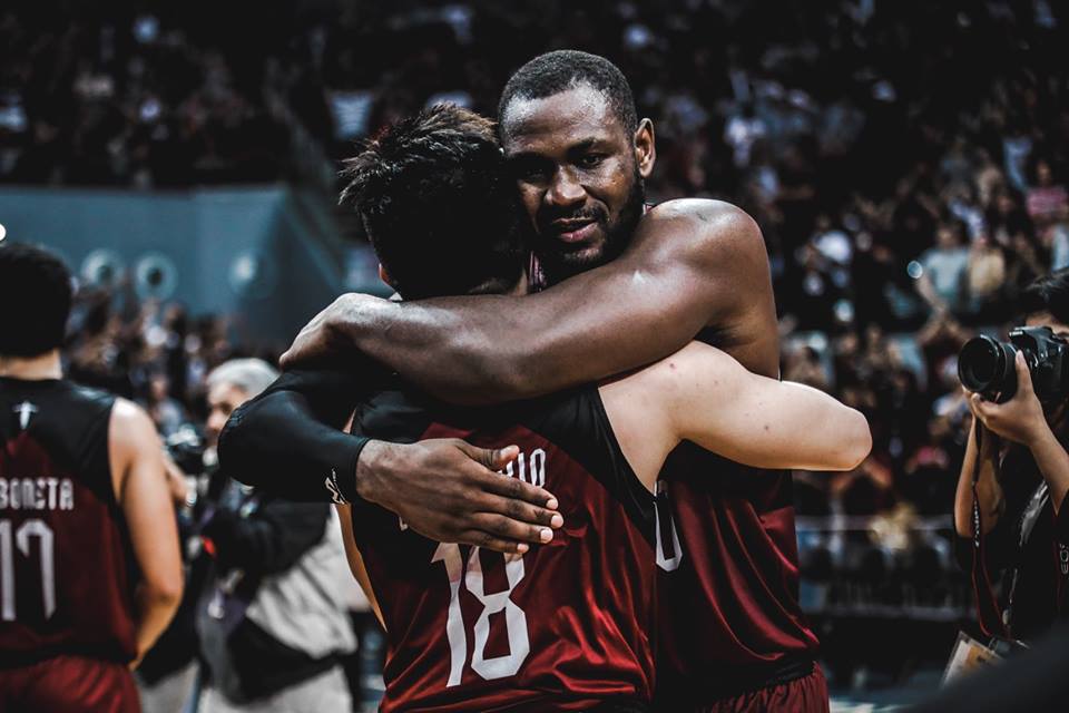 MVP Bright Akhuetie embraces his teammate Paul Desiderio after UP secured the must-needed win against Adamson