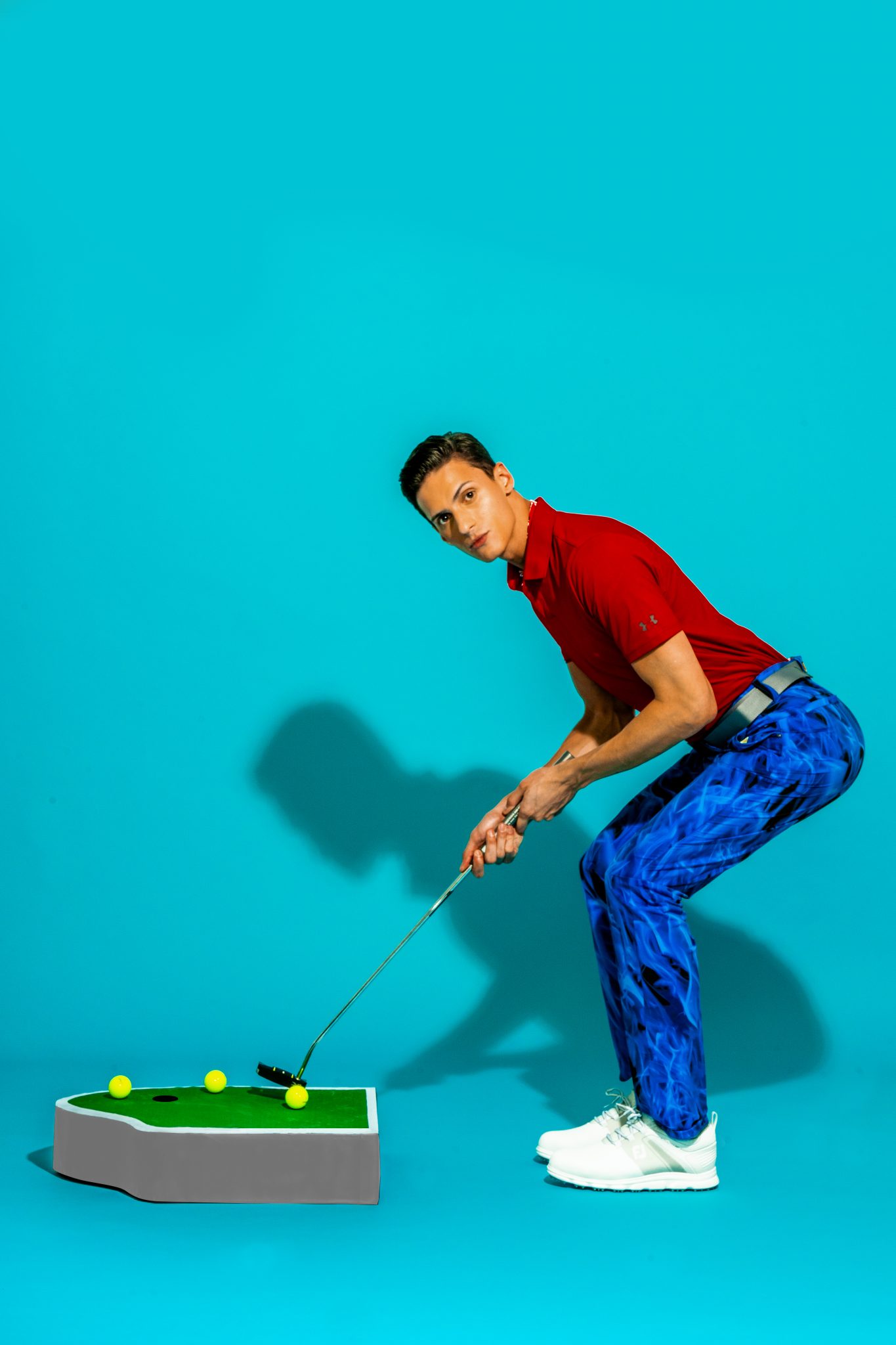 Under Armour polo shirt and belt; Loudmouth printed shirt and pants, Footjoy SuperLites XP shoes, Titleist golf balls, and Hybrid club all from Empire Golf & Sports