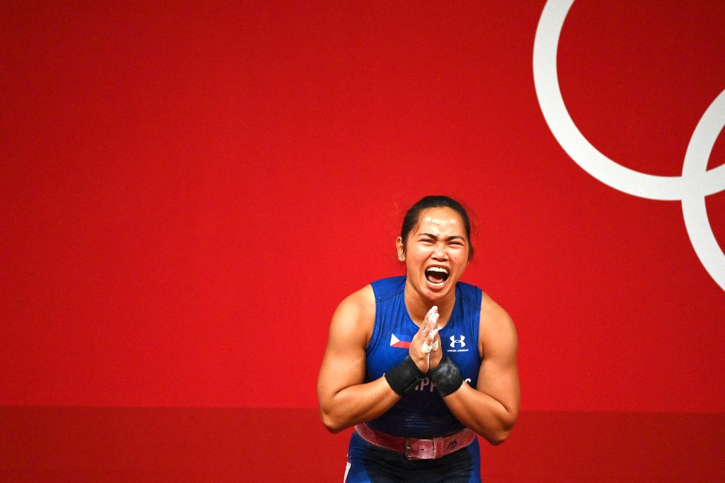 Hidilyn Diaz reacts after winning the women's 55kg weightlifting competition at Tokyo 2020 Olympics
