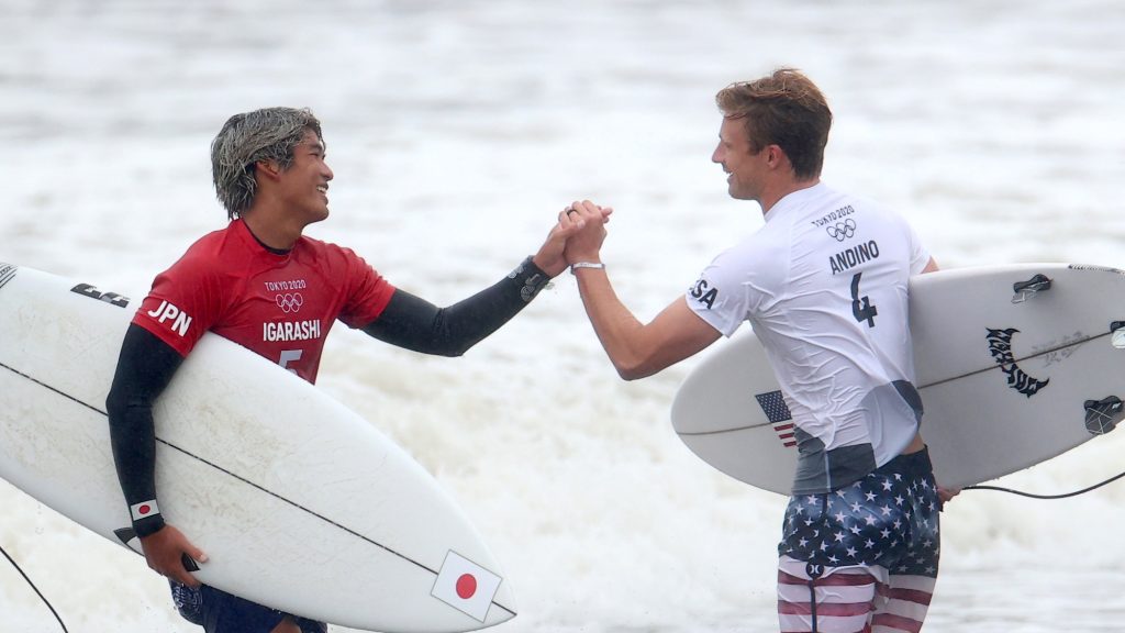 Surfing quarterfinal action: Kanoa Igarashi of Japan shakes hands with Kolohe Andino of the United States after competing in Heat 1