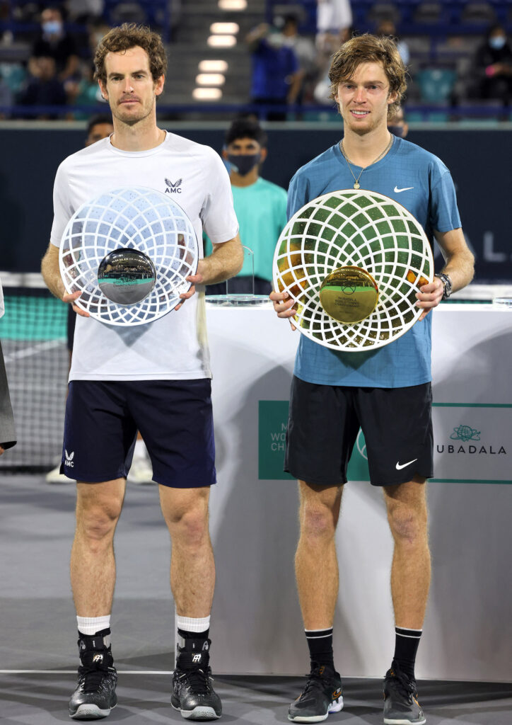 First place winner Andrey Rublev (right) of Russia holds up his trophy alongside runner-up Andy Murray of Britain during the awards ceremony after the final match of the Mubadala World Tennis Championship