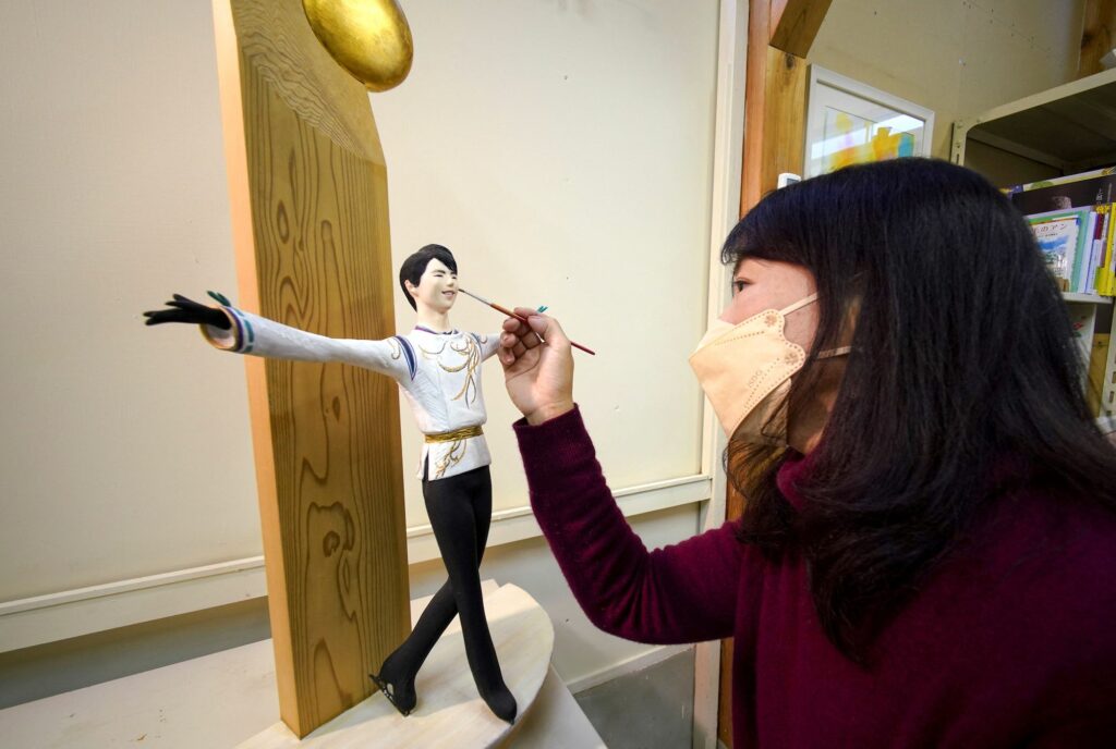 Yumi Matsuo finishing a wood carving statue of Japanese figure skater Yuzuru Hanyu