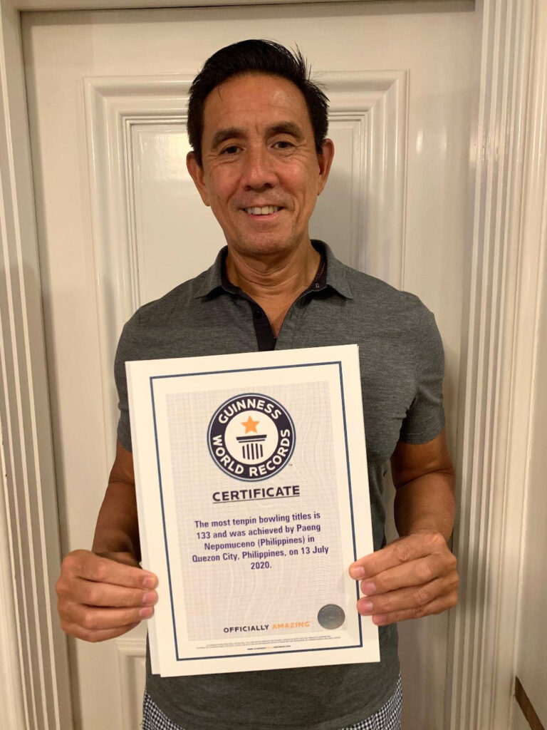 Paeng Nepomuceno proudly holding his fourth Guinness World Records certificate