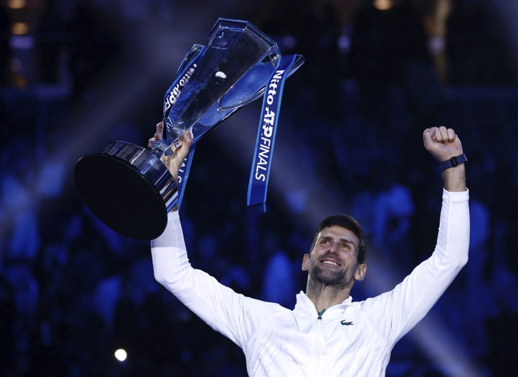 Serbia's Novak Djokovic celebrates with the trophy after winning the men's singles final of the ATP Finals against Norway's Casper Ruud