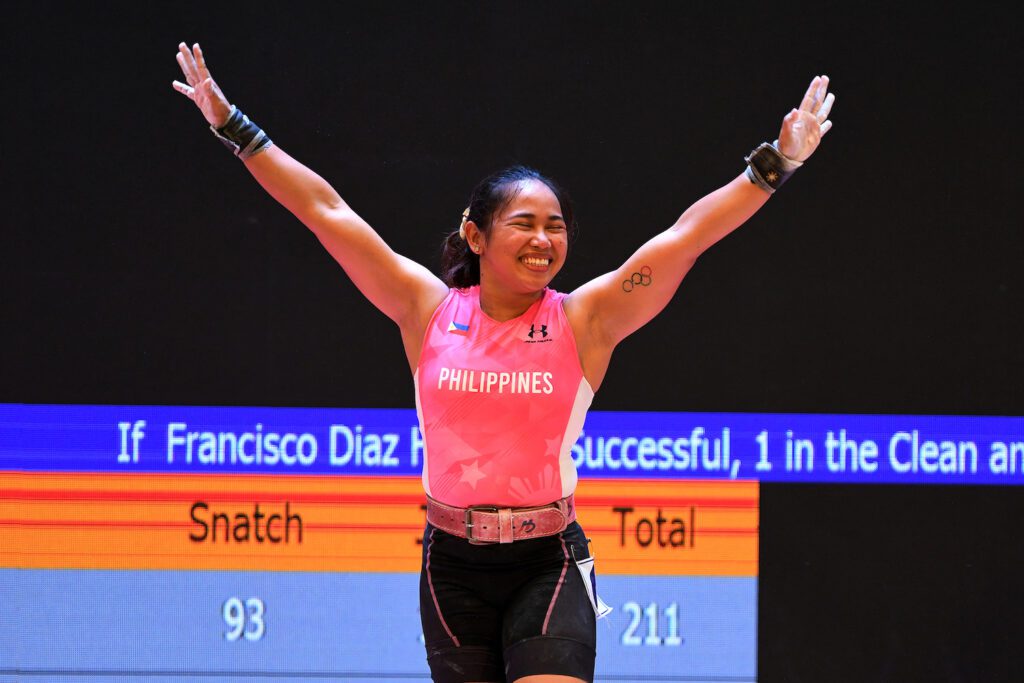 Philippines' Hidilyn Diaz celebrates as she wins gold in the women's 55kg weightlifting event during the 31st Southeast Asian Games (SEA Games) in Hanoi