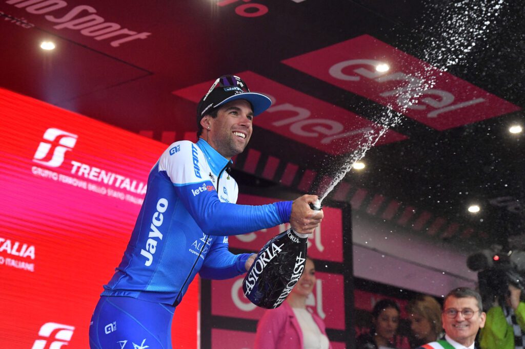 Team Jayco AlUla's Michael Matthews sprays sparkling wine as he celebrates on the podium after winning Stage 3