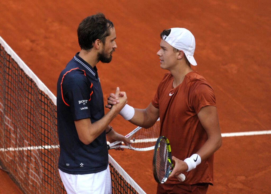 Daniil Medvedev and Holger Rune shake hands at the net after the men's singles final