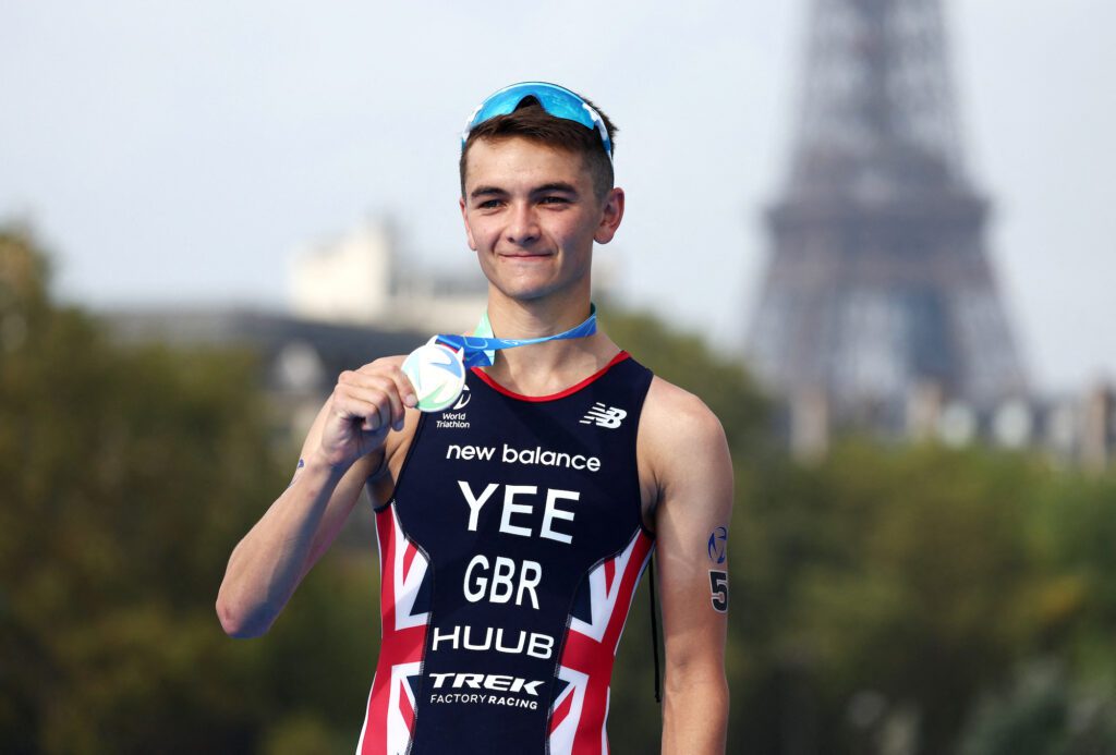 Britain's Alex Yee celebrates on the podium after winning the elite men triathlon test event REUTERS/Stephanie Lecocq
