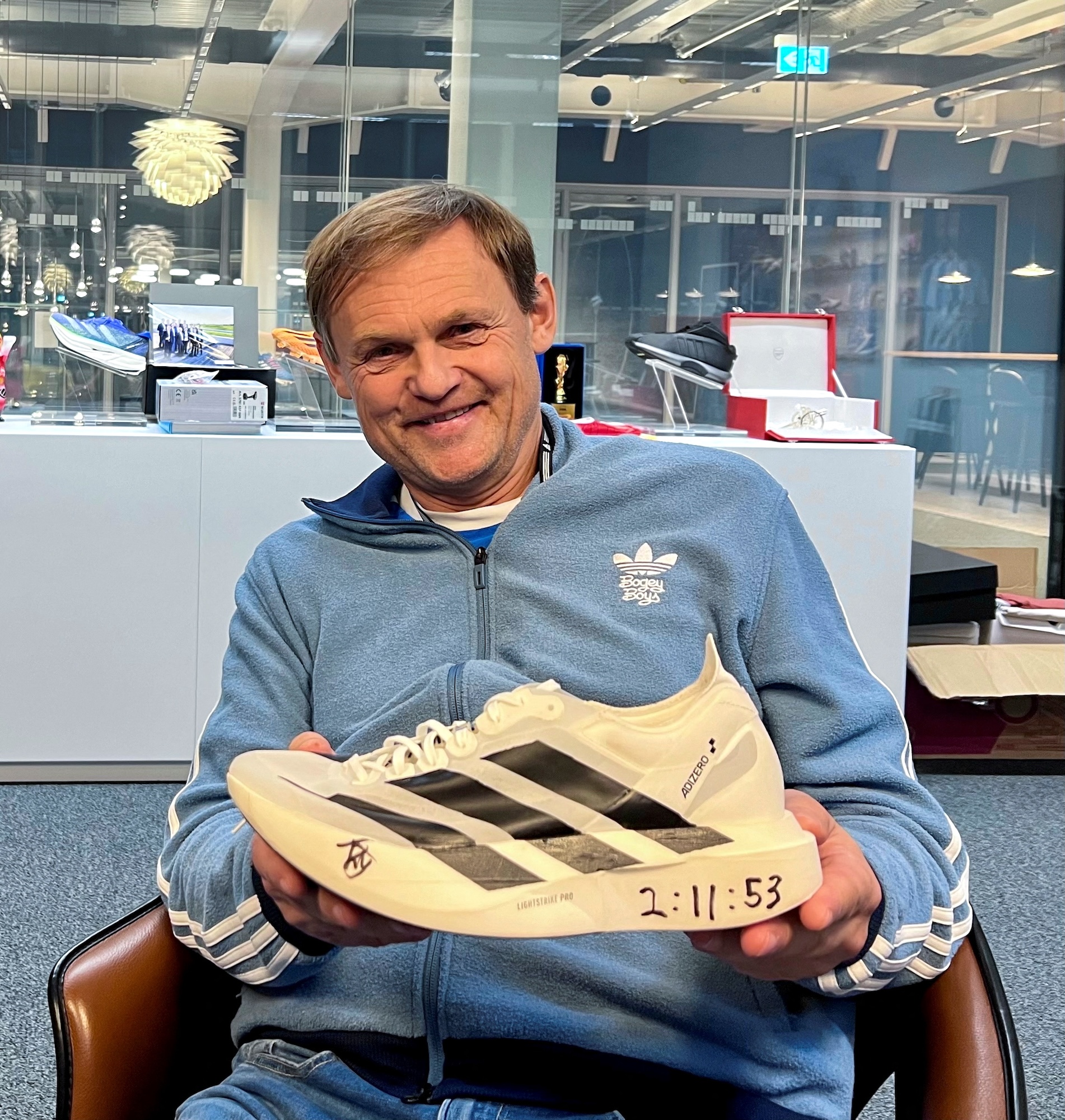 Adidas CEO Bjorn Gulden, holds a shoe worn by Ethiopia's Tigist Assefa when she set a new women's world record at the Berlin Marathon, finishing in 2 hours, 11 minutes and 53 seconds, during an interview at Adidas headquarters in Herzogenaurach, Germany, November 20, 2023. REUTERS/Helen Reid/File Photo