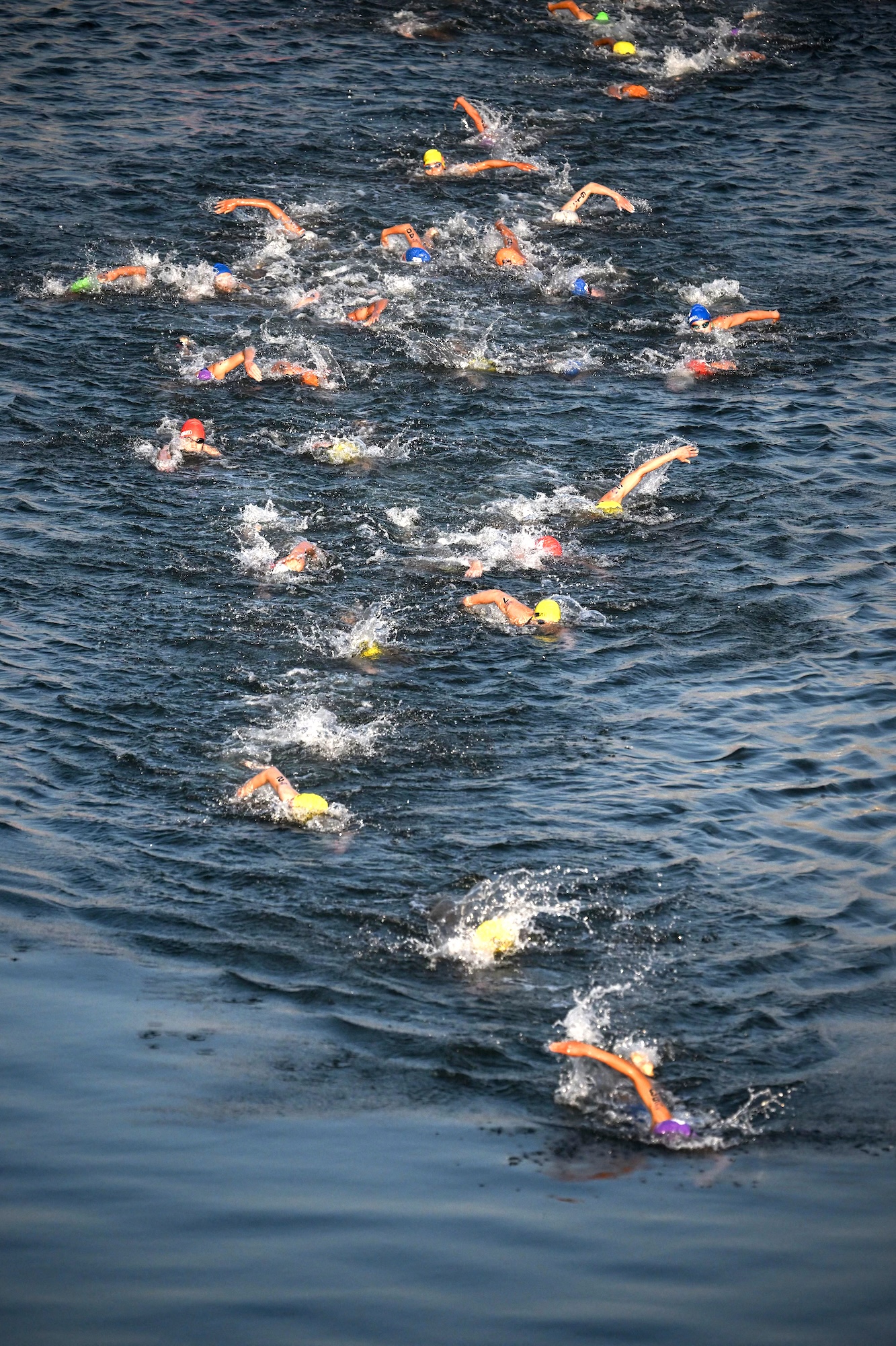 Triathlon athletes compete and swim in the Seine river during a test event for the women's triathlon for the upcoming 2024 Olympic Games in Paris on Aug. 17, 2023